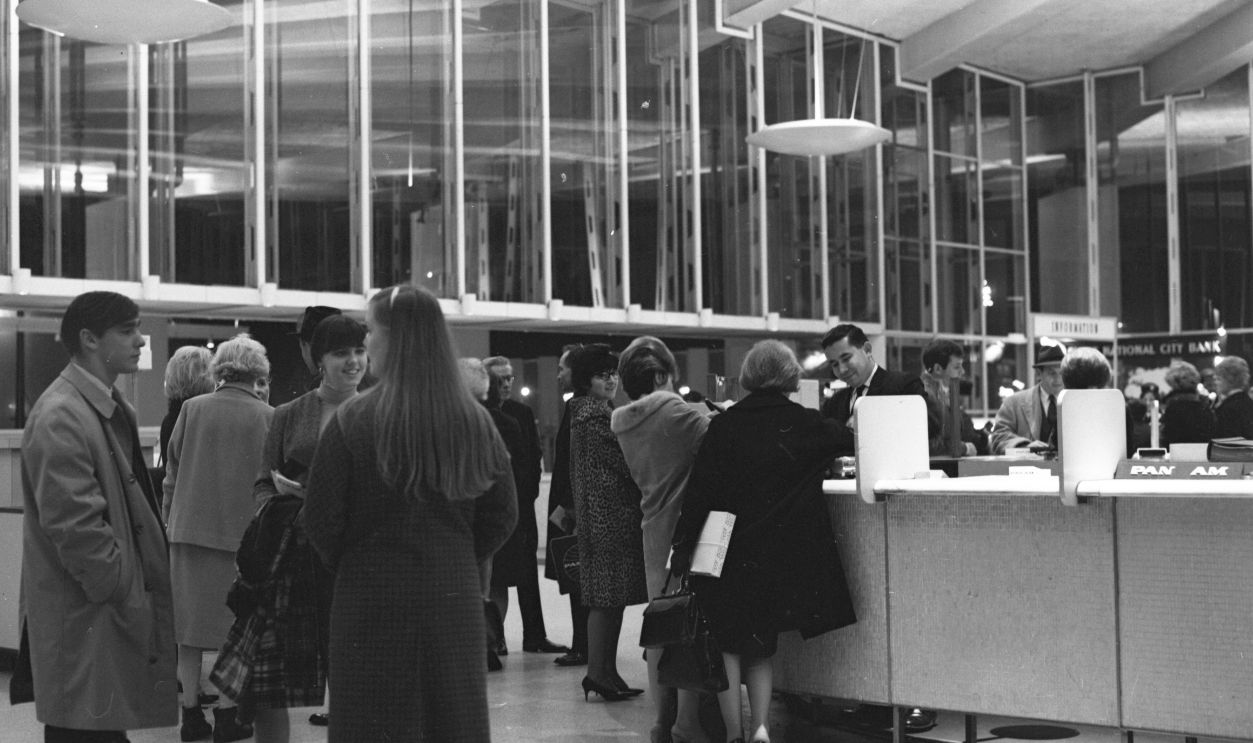 Customers queue for boarding passes at the ticketing desk at the Pan American Terminal in Kennedy Airport.