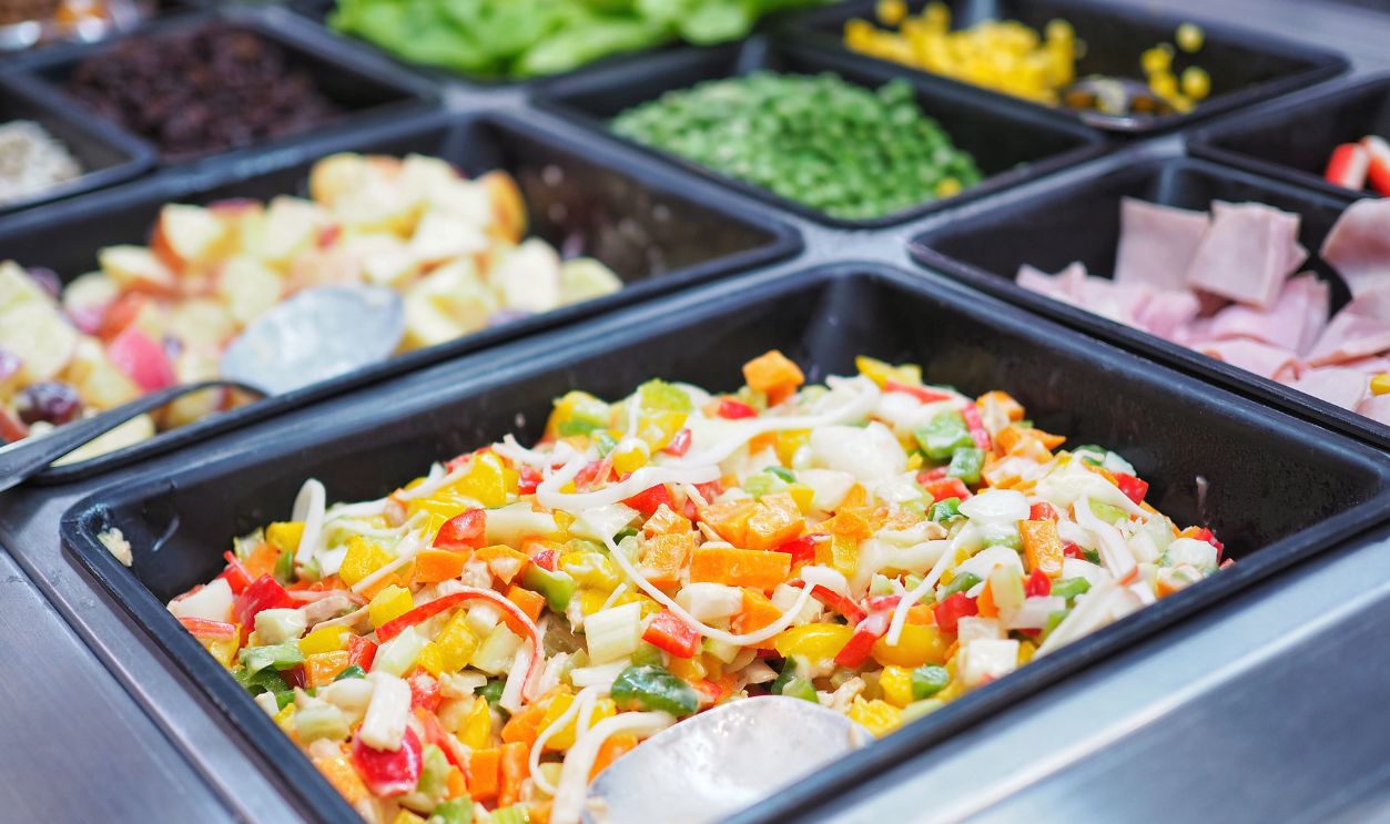 Salad bar buffet are available for sale in the food supermarket which there are many fresh vegetable, fruit and cereal grain in the tray for customer to buy back to eat at home, Healthy diet