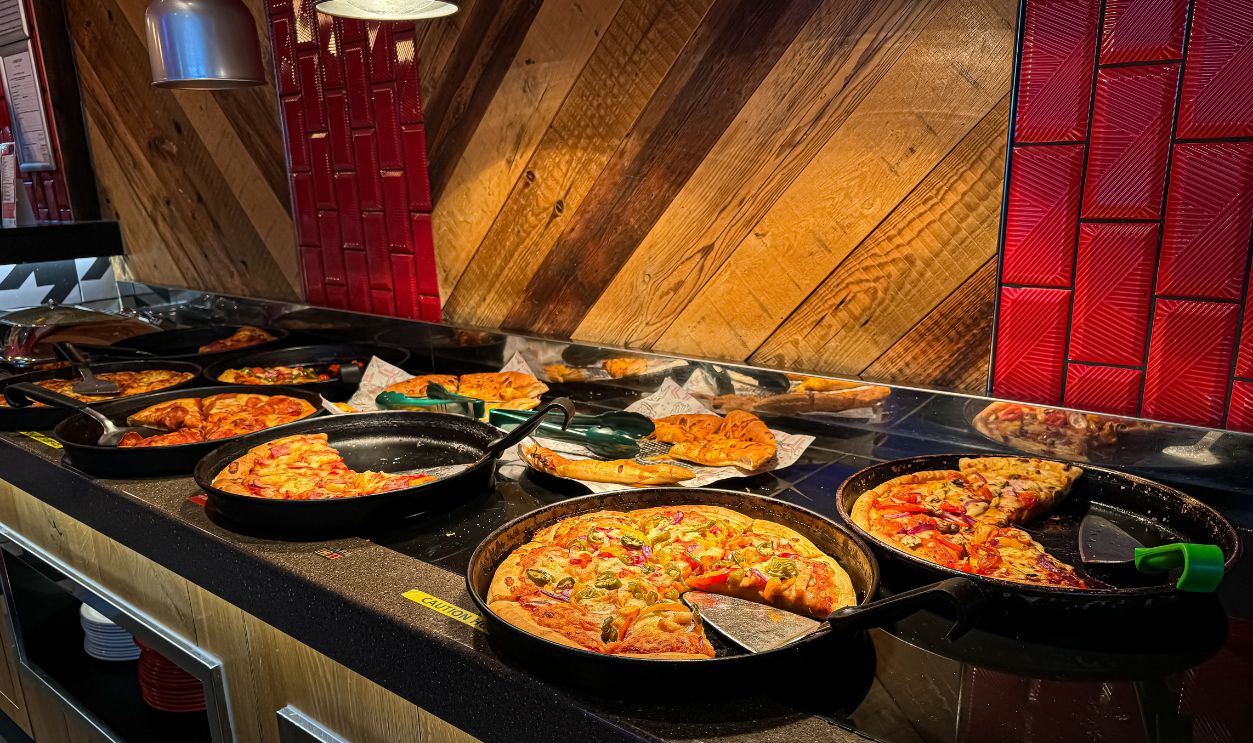 EDINBURGH, SCOTLAND - 01 September 2024 Sliced Pizzas on the Hot Self Service Buffet Counter at a Pizza Hut Restaurant in Edinburgh Scotland