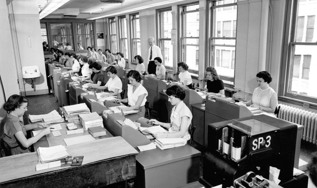 Rows of women office workers entering data using keypads and punch cards at the Erie Railroad offices, Cleveland, Ohio, circa 1960.