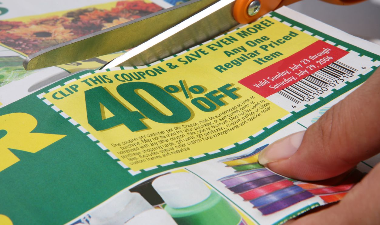 Woman cutting a store coupon