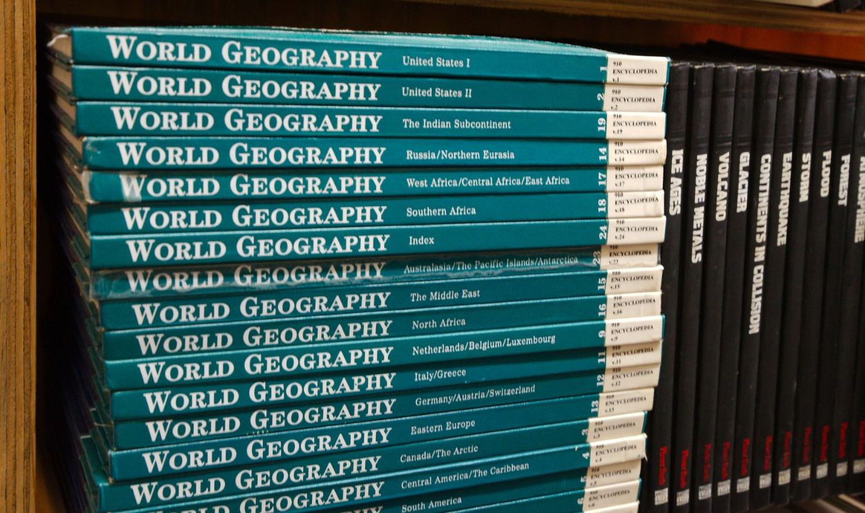 Row of Vintage Encyclopedia Bound Reference Volumes on a Wooden Shelf, Classic Library Collection Editorial Use Only Largo,FL USA, April 22, 2026. Evoking vintage library, research, education and archival themes with warm tones and classic gold embossing.