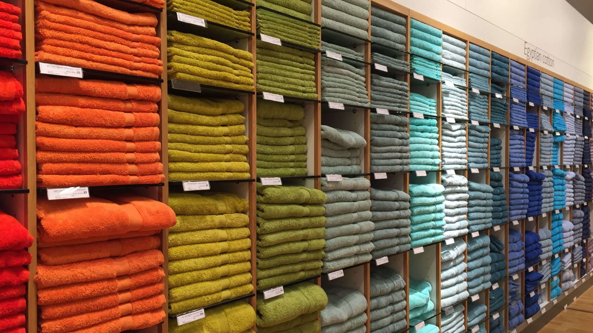Multicoloured bath towels in the John Lewis department store in Reading, Berkshire, UK.
