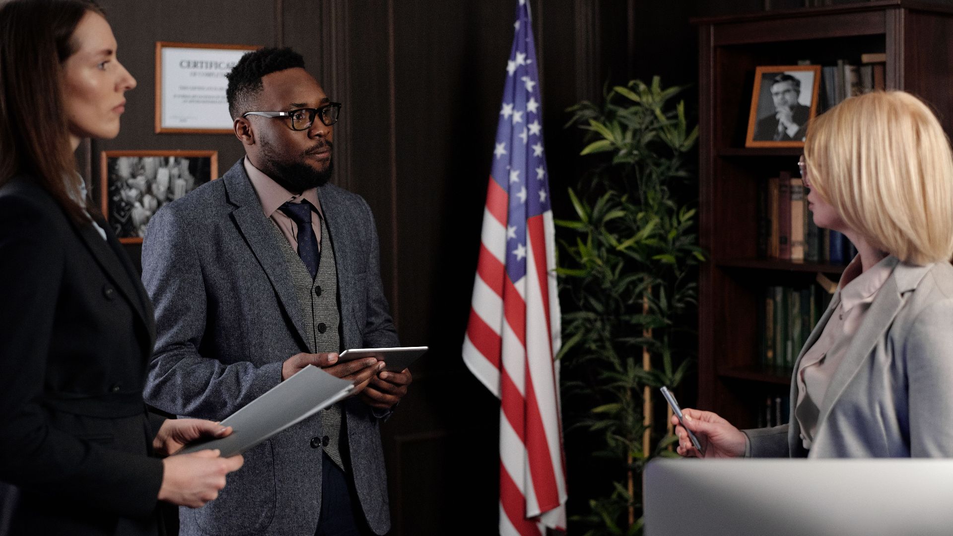 Business professionals in formal discussion, advocating teamwork and diversity.