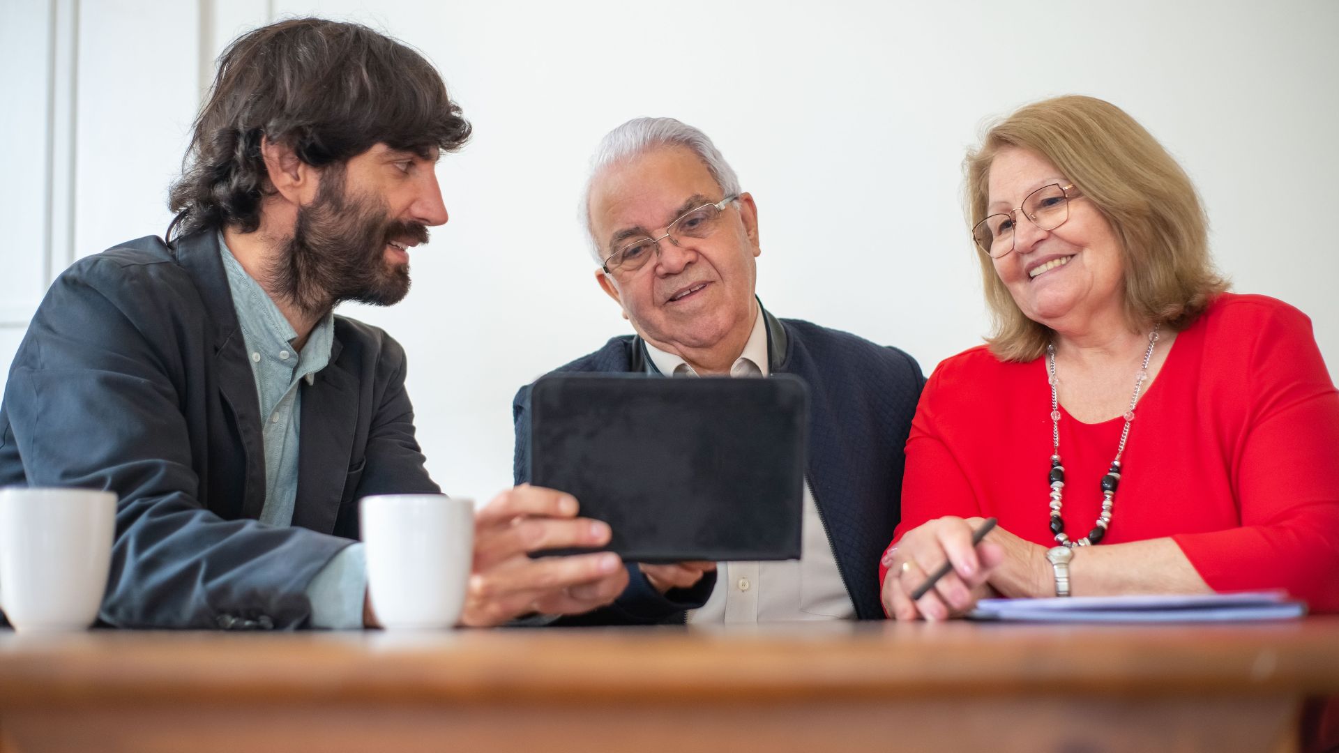 Elderly couple in a meeting with consultant, exploring financial or insurance options.