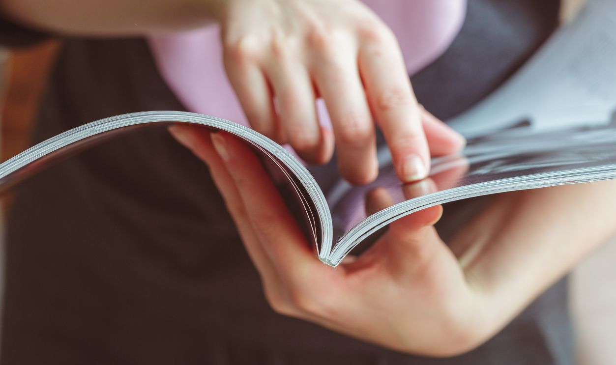 woman reading magazine at home
