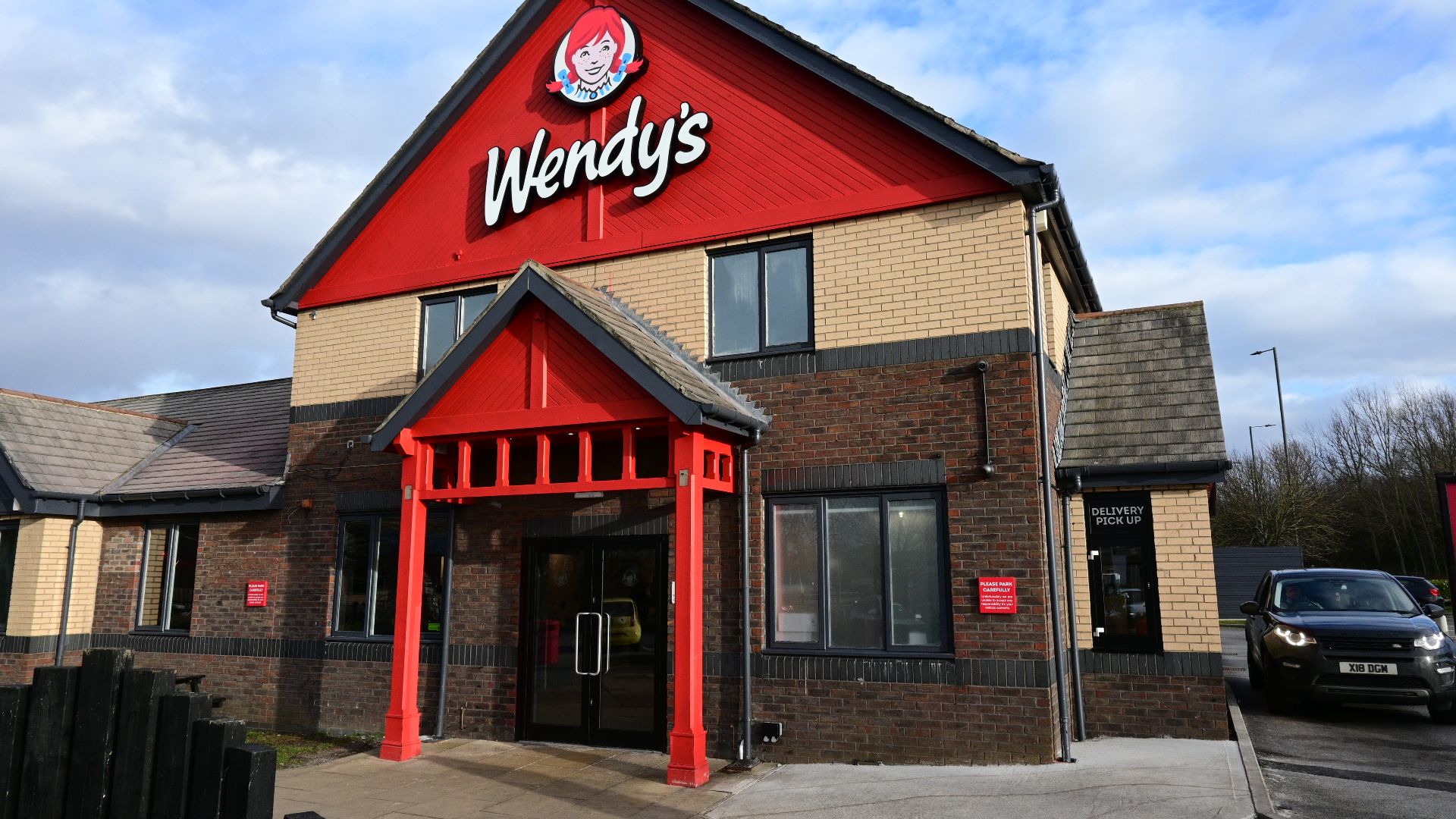 The main entrance and adjoining drive-through bay of the new Wendy's restaurant in Kingswood, Kingston upon Hull. Touted as the 'world's biggest' by the company, it is situated in the former site of a Papa's fish and chip shop and drive-through, with oper