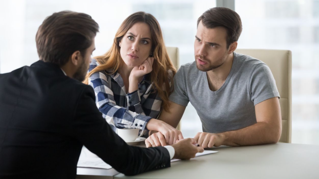 Shutterstock-1302585082, Angry dissatisfied couple arguing meeting lawyer or manager having legal fight complaints on bad client service, annoyed mad customers claiming change in contract terms demanding fraud compensation