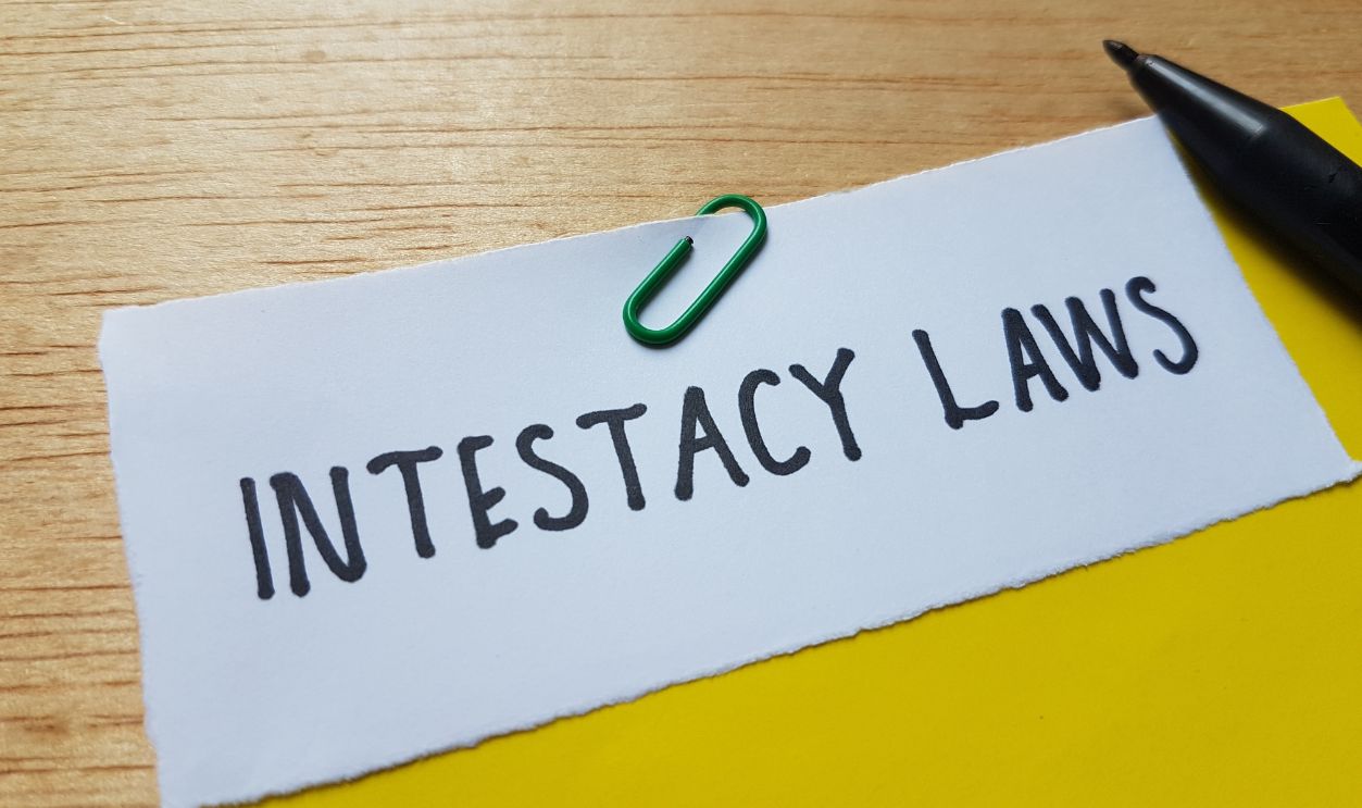 Intestacy laws written on blue background.
