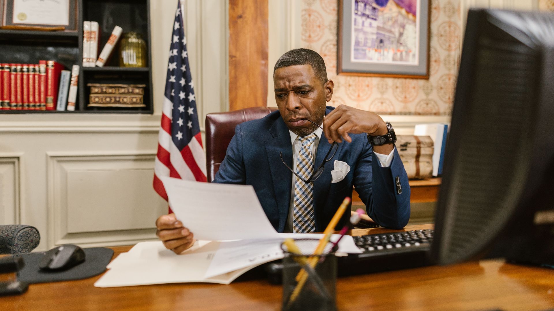 A focused lawyer reading documents in an office, symbolizing professionalism and legal expertise.