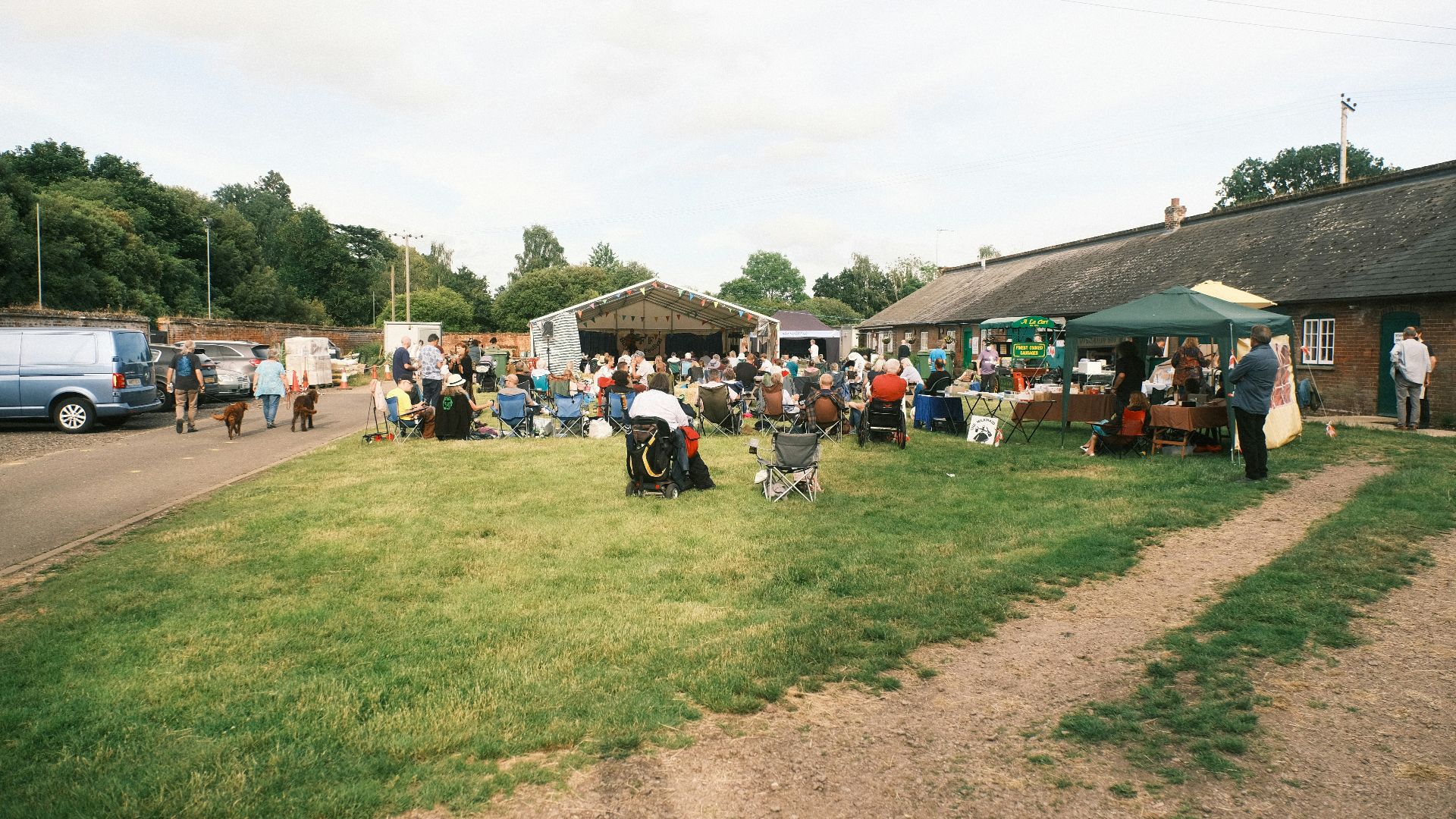 a group of people standing in a field next to a building