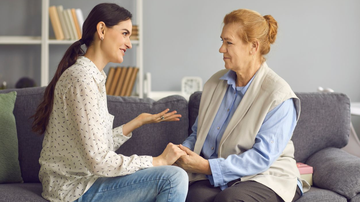 Shutterstock-1969127353, Grown-up daughter talking to senior mother. Happy daughter and friendly mother-in-law sitting on sofa and having sincere honest conversation. Mutual understanding, family supporting each other concept