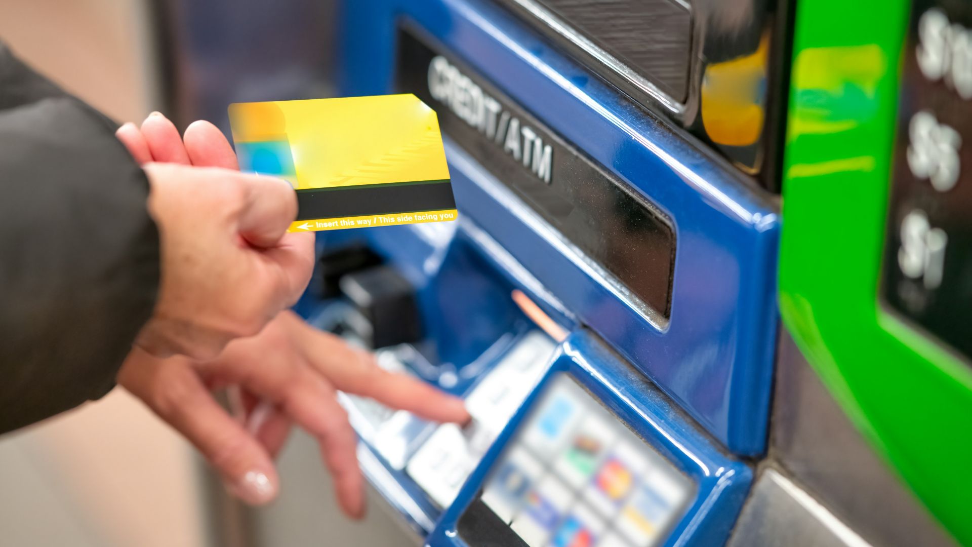 a person using a credit card to pay for a machine