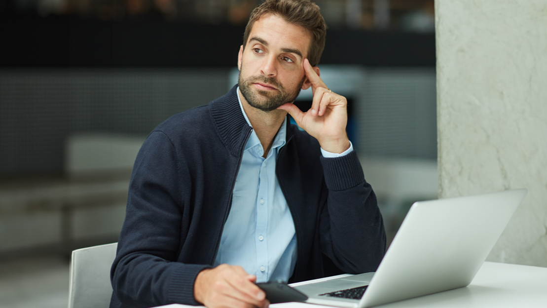 Serious, businessman and thinking with laptop