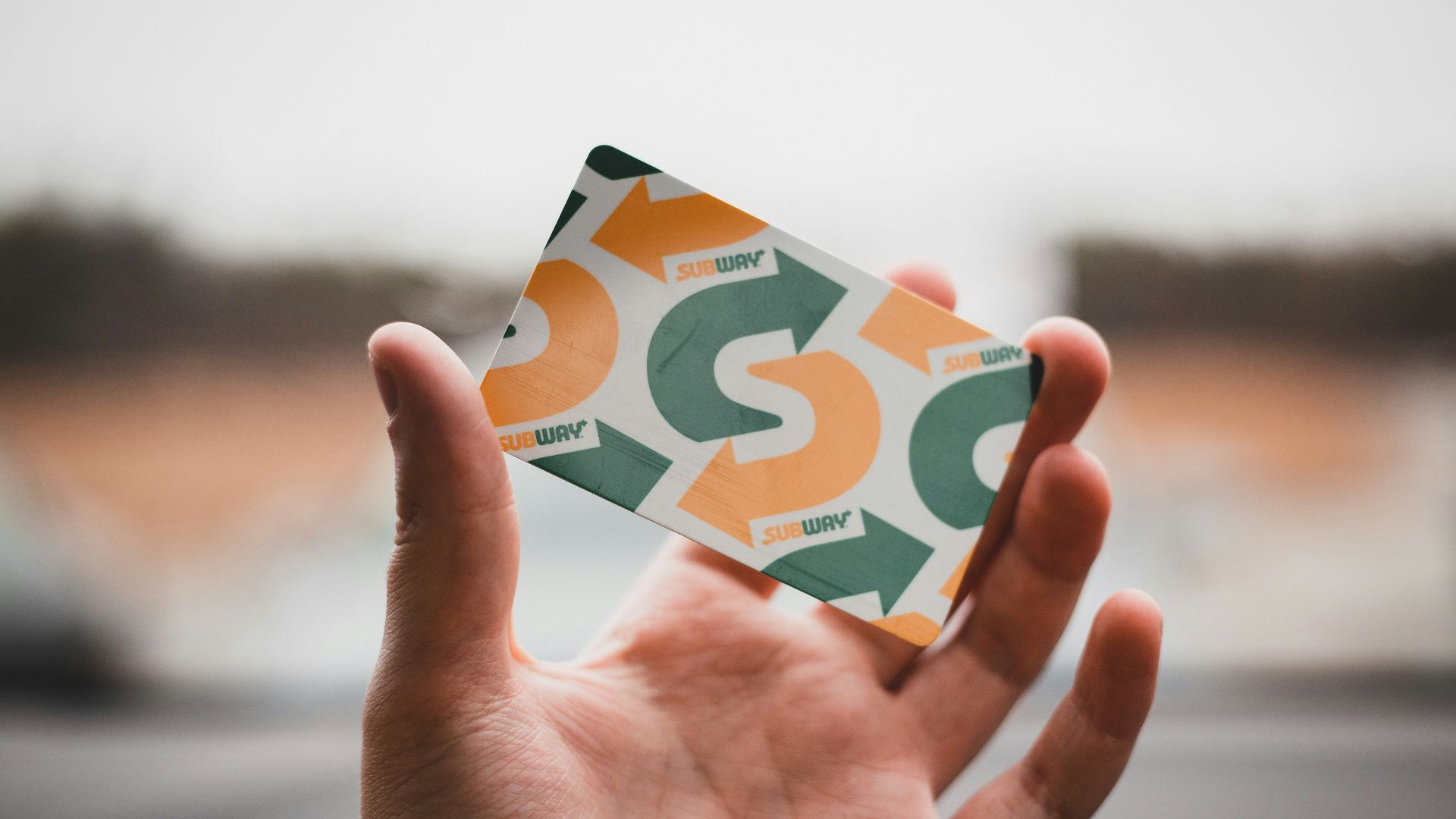 person holding green and white card