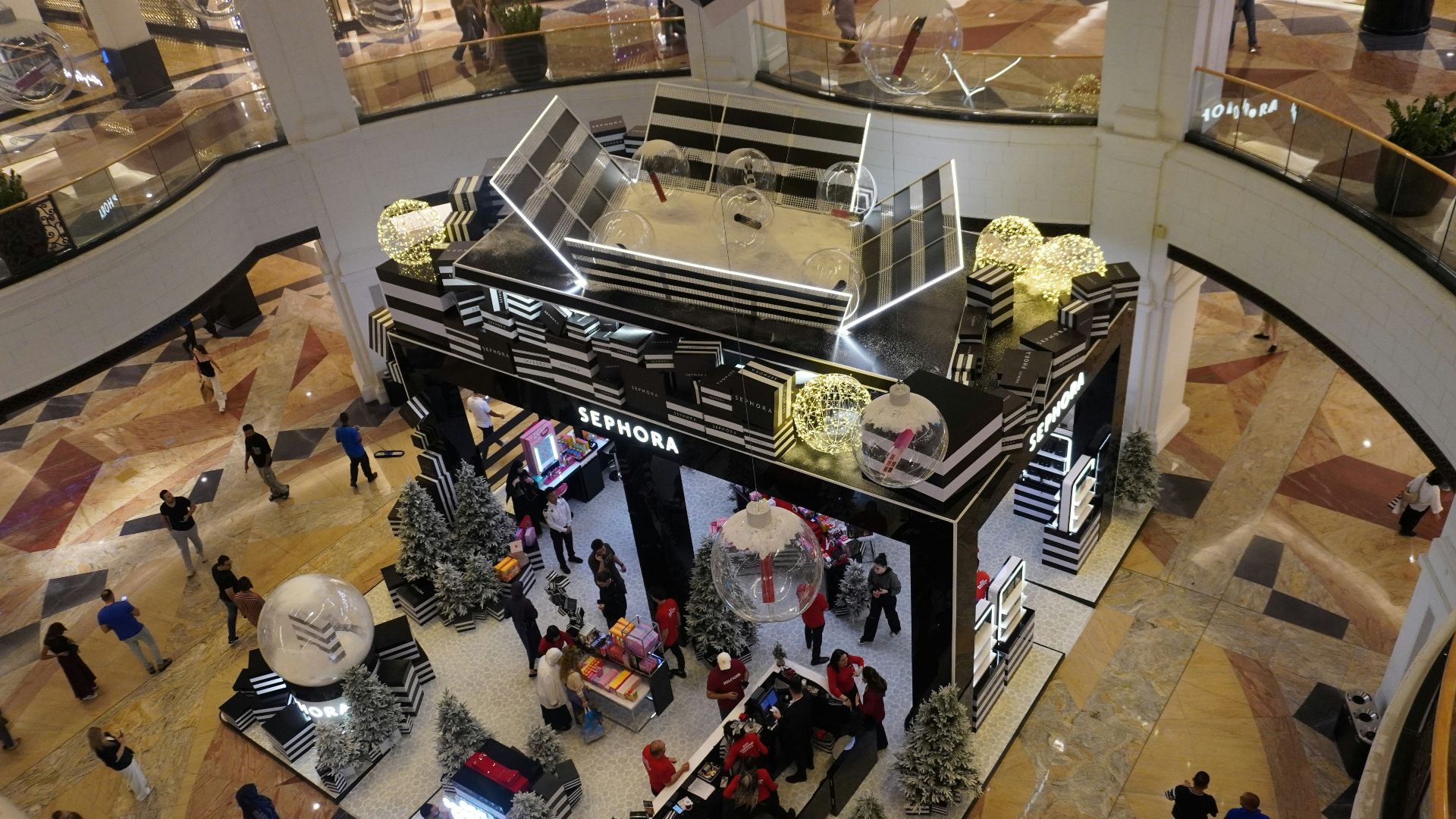 People shopping in a modern, multi-level mall
