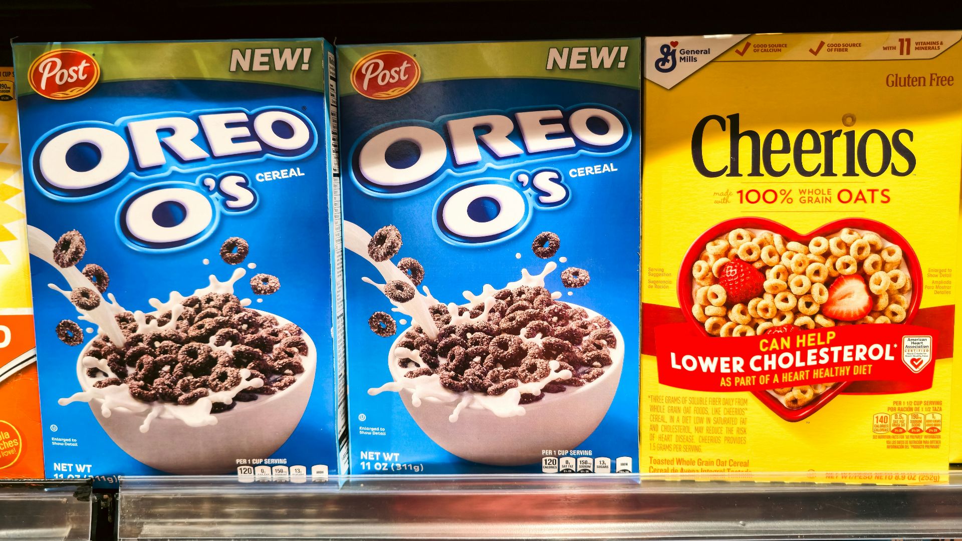 Boxes of oreo o's and cheerios cereal on shelf