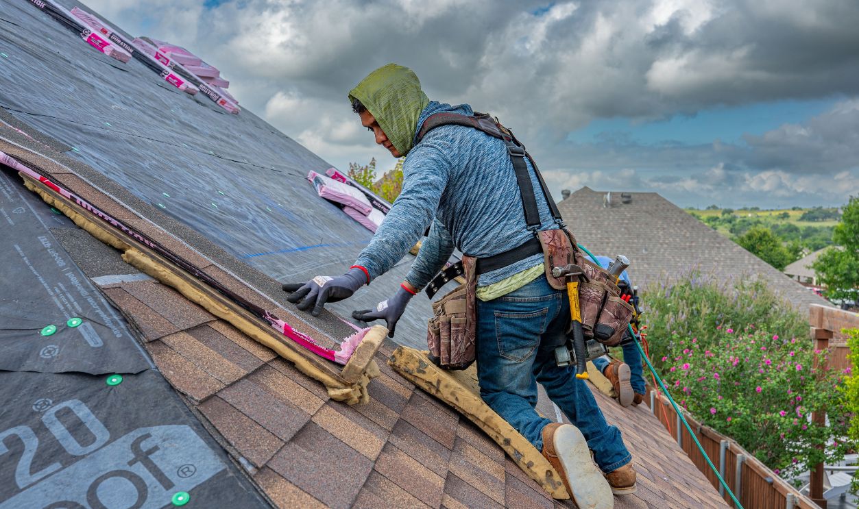 Roofers working on shingle installation on a home in Fort Worth