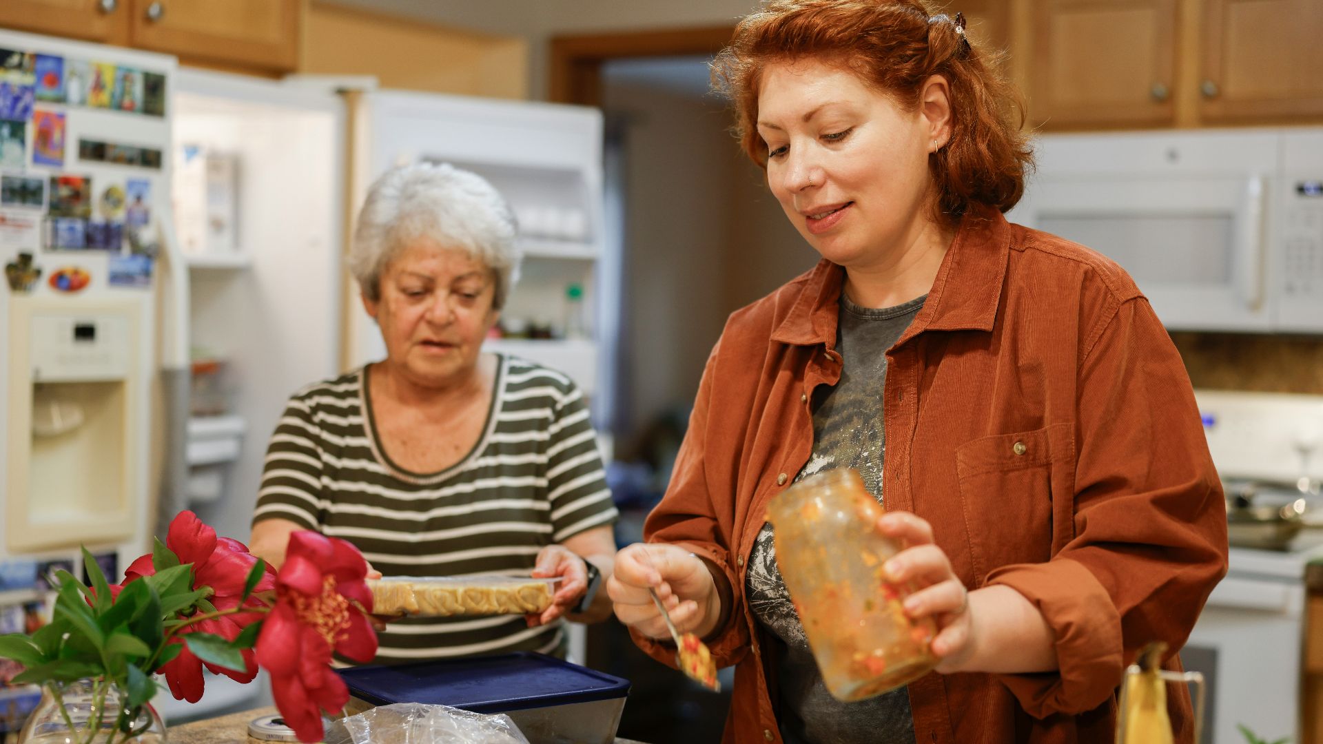 Two women preparing food in a kitchen