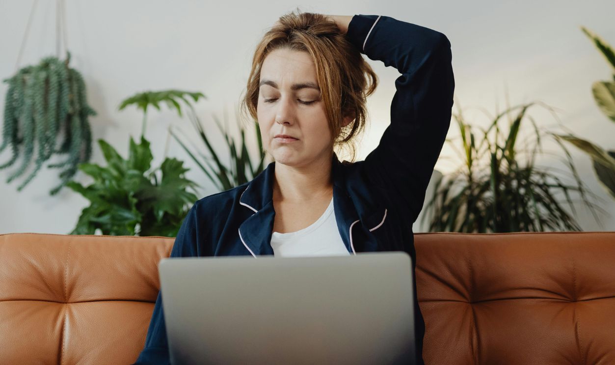 Woman in Blue Long Sleeves Sitting Near the Green Plants