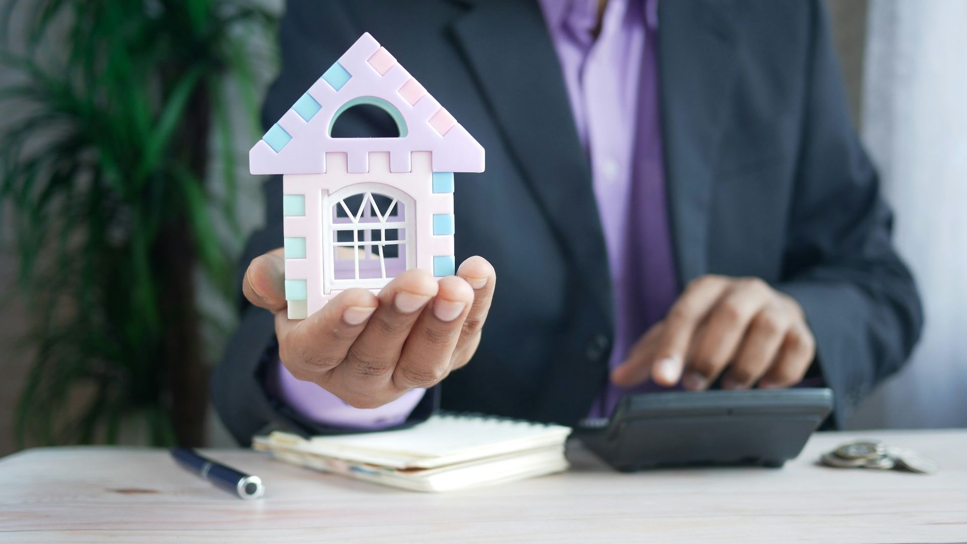man in purple suit jacket using laptop computer