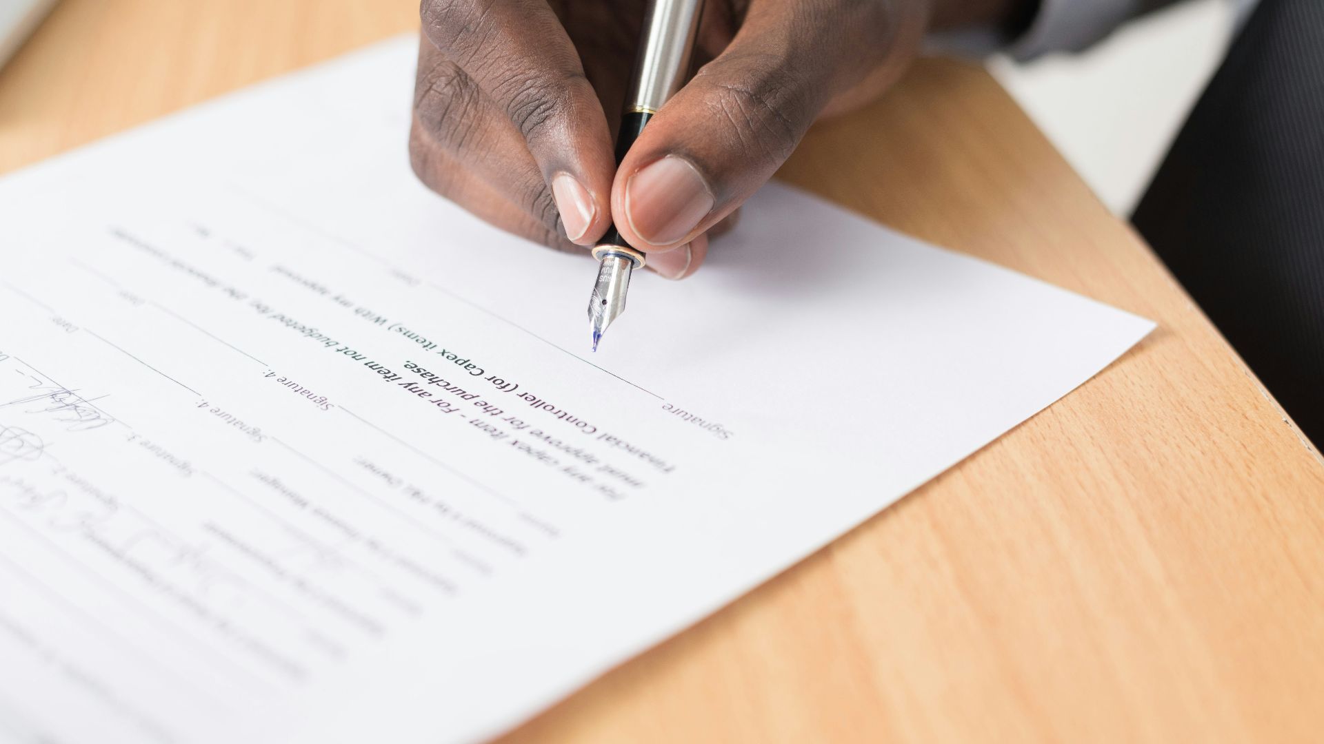 person writing on white paper