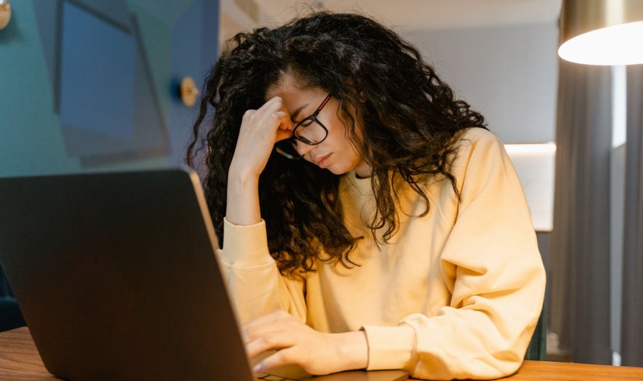 A Tired Woman using a Laptop