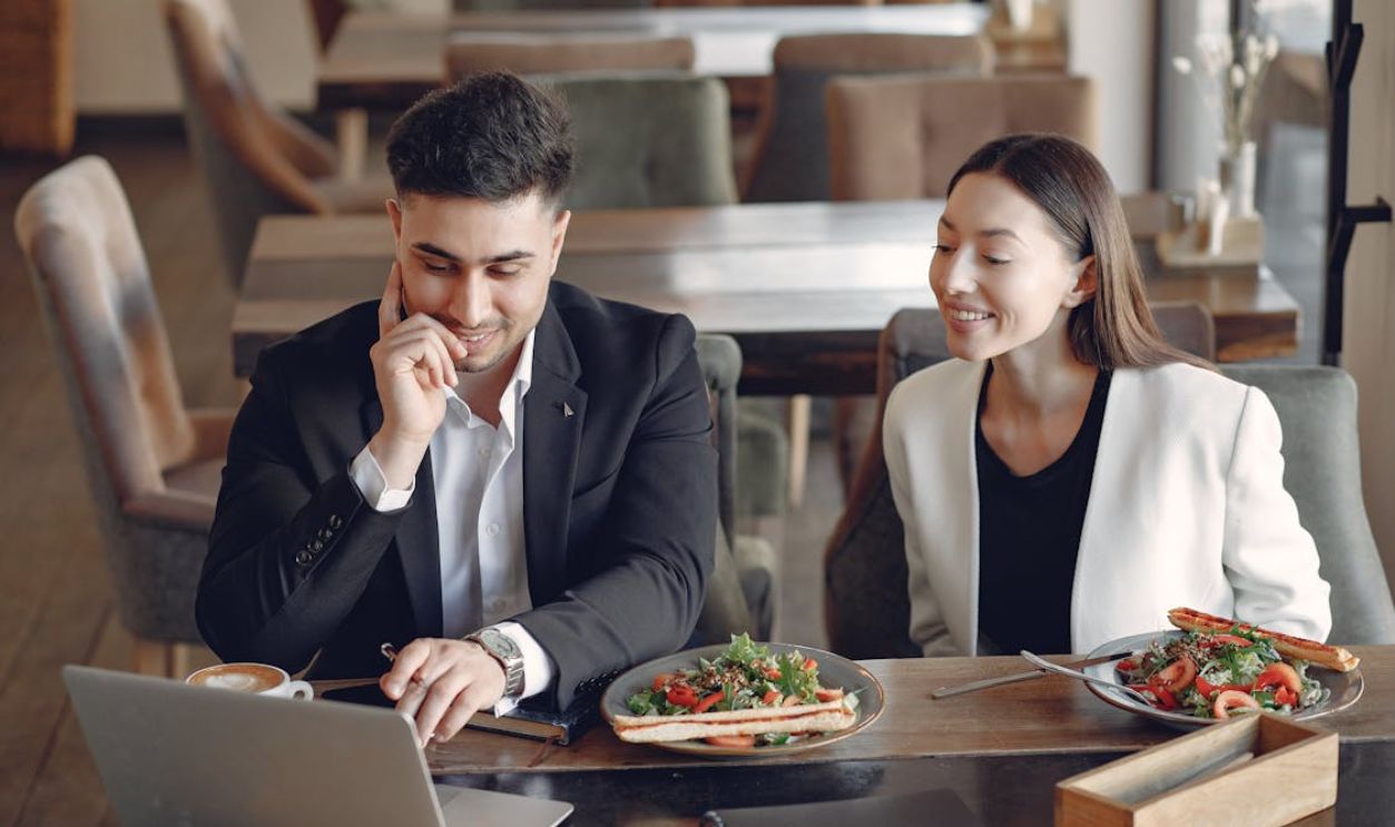Positive diverse businesspeople working in cafe