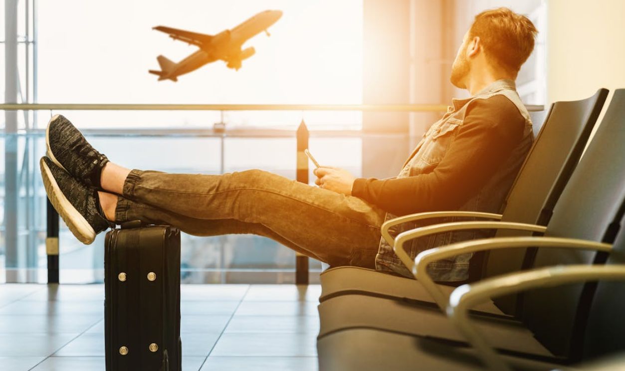 Man in airport waiting for boarding on plane