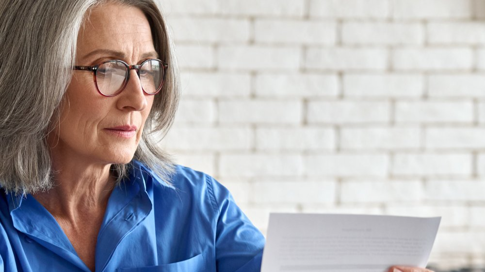 Adult senior 60s woman working at home at laptop