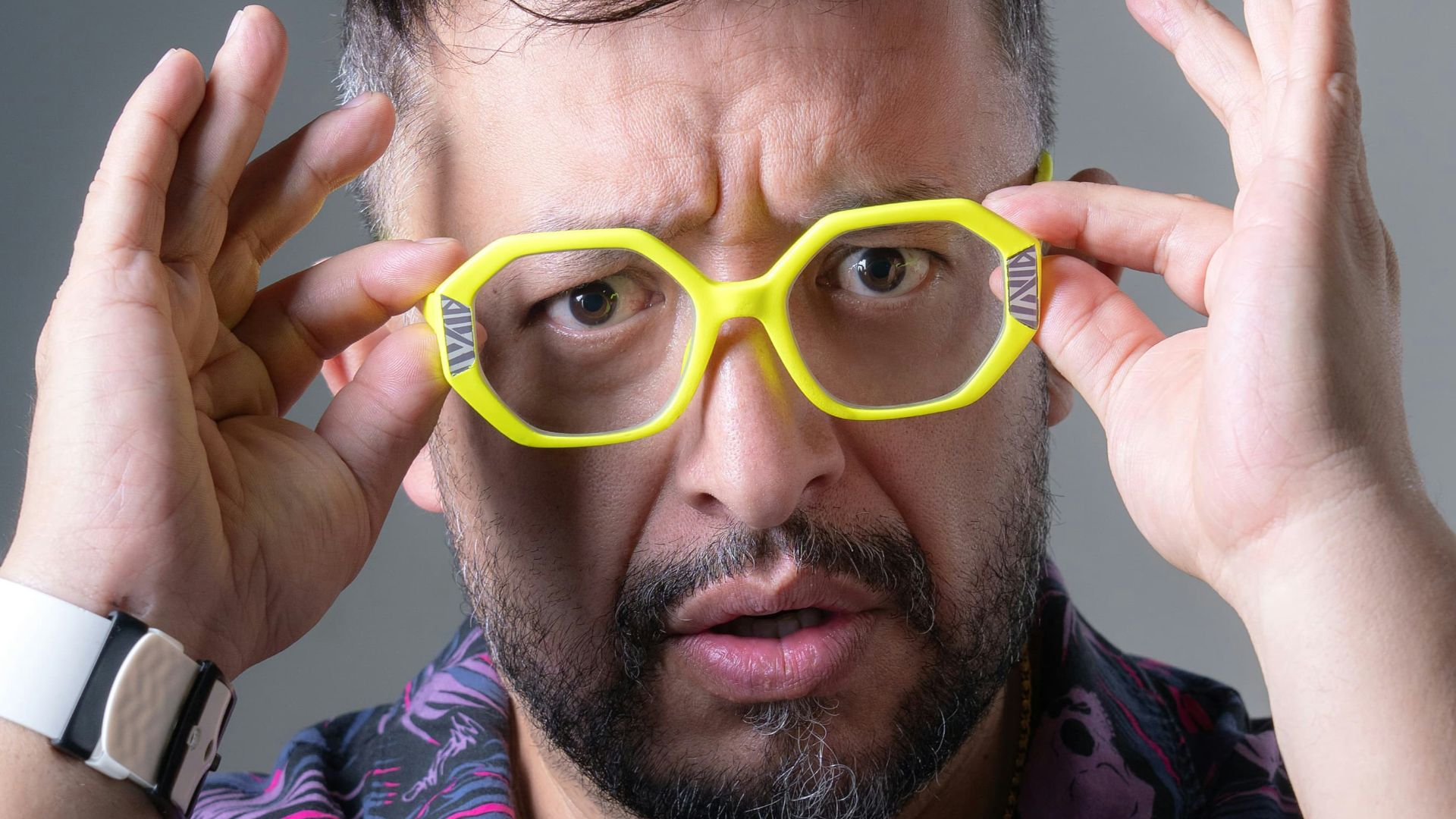 Man with yellow glasses looking surprised