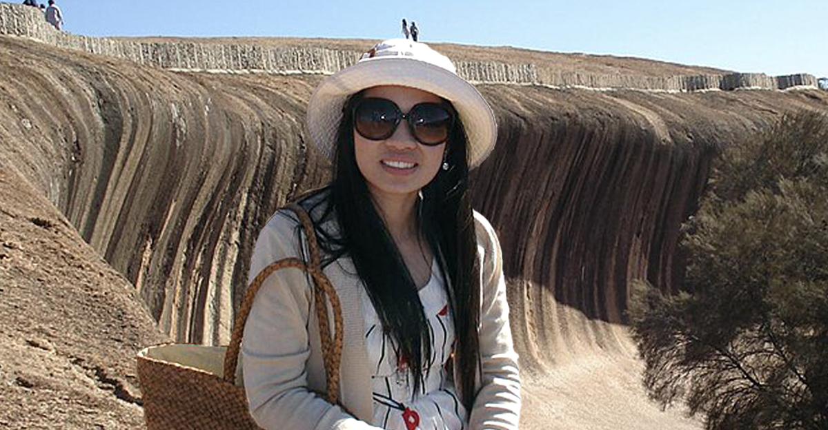 woman in sunglasses in front of wave rock, australia