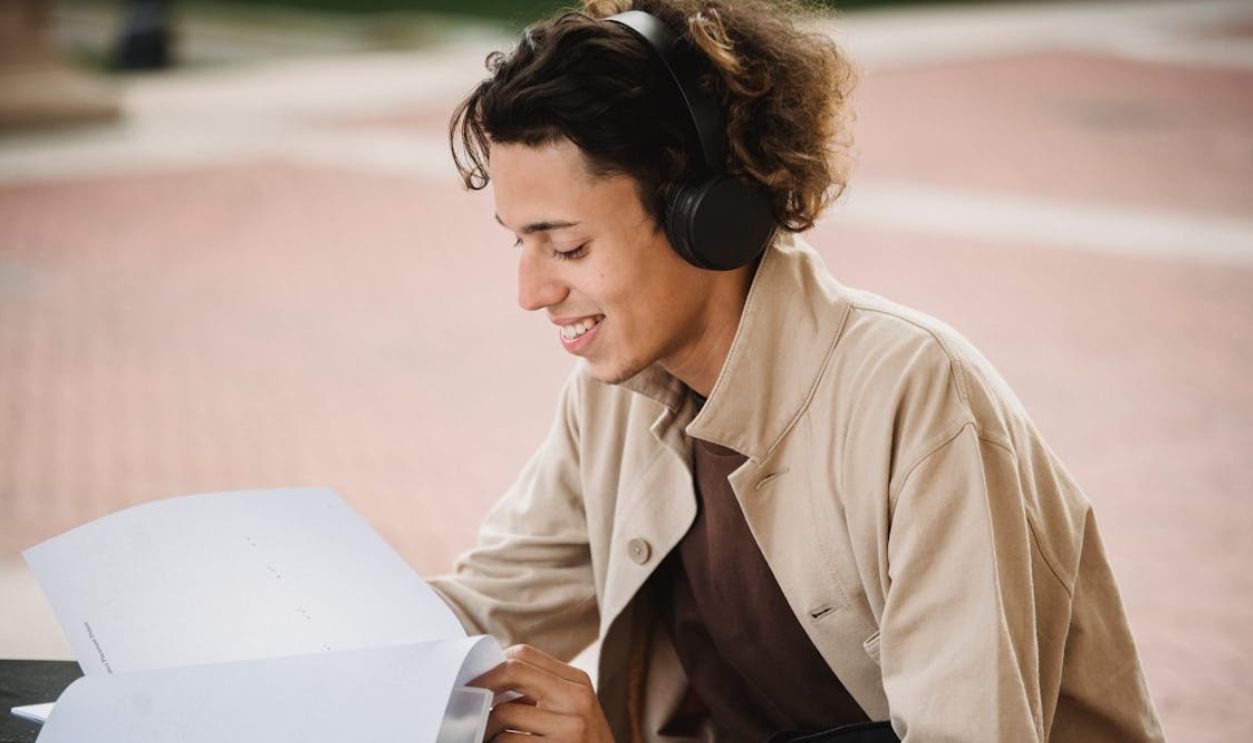 Positive man reading document for studies