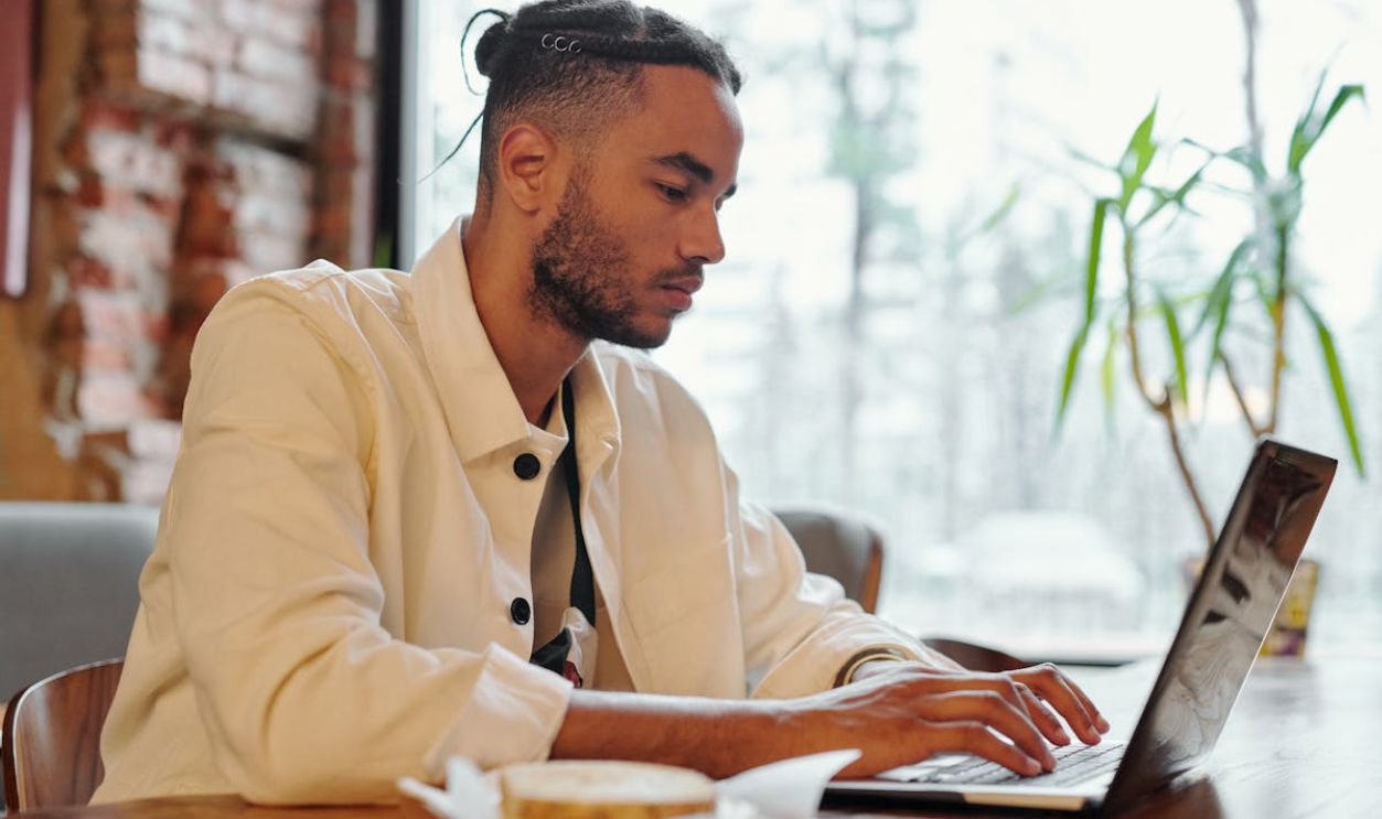 Focused Man using Gray Laptop