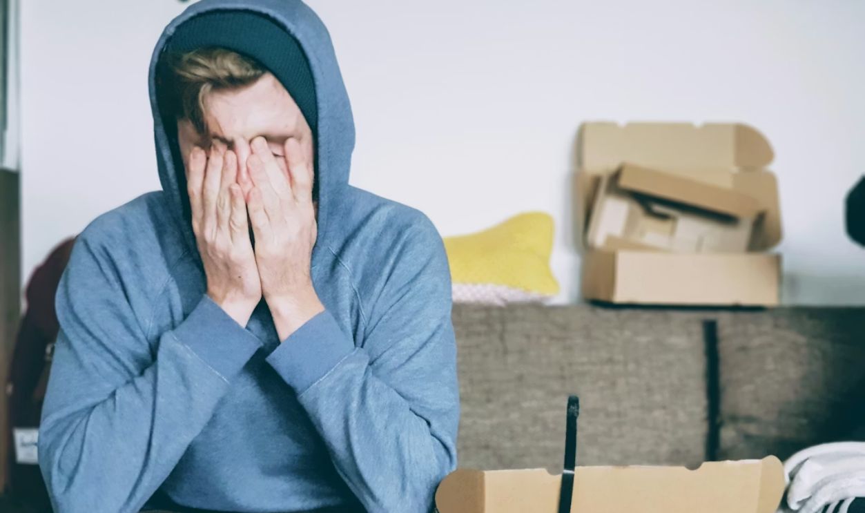 Young man looking stressed over bills
