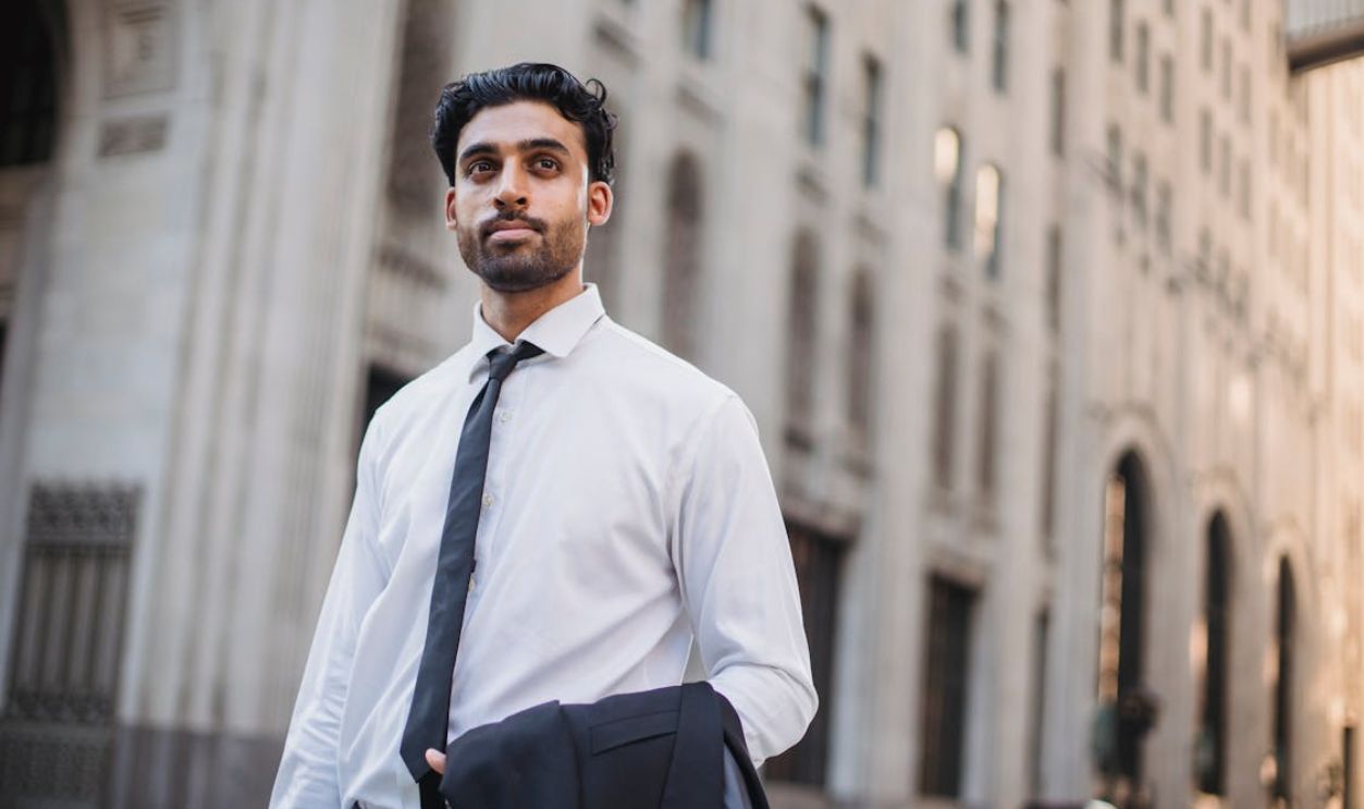 Handsome Young Man in White Shirt and Black Tie in City Street
