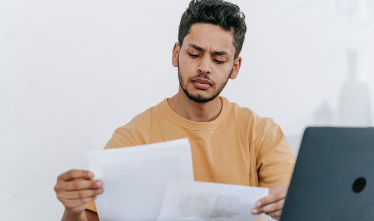 Man looking through documents at workplace