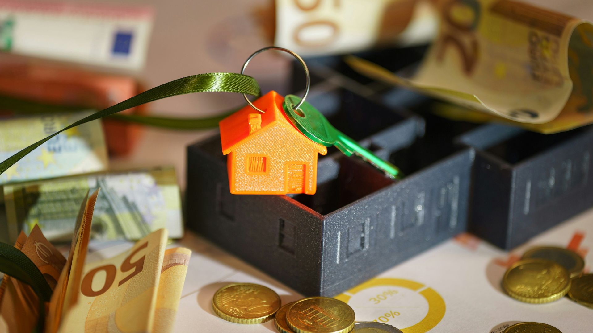 A small house on top of a pile of money