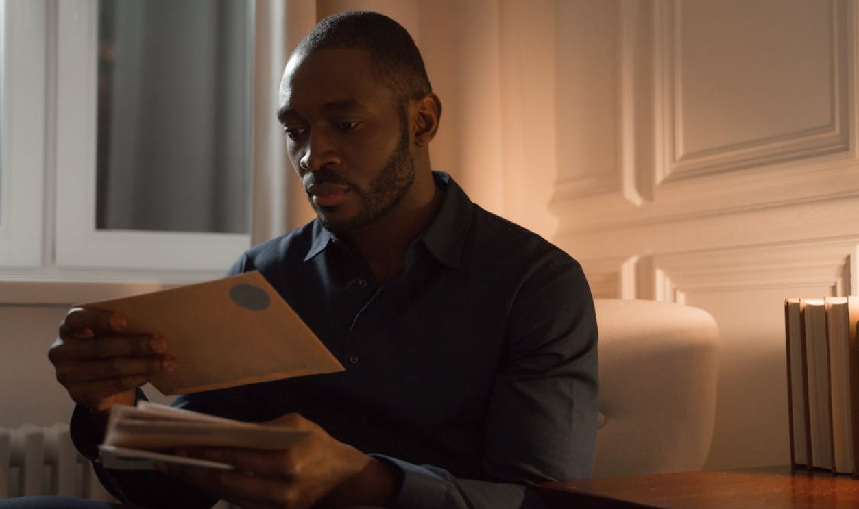 Man Reading Letters