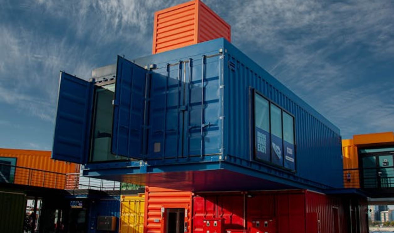 Colorful Stacked Shipping Containers Under Blue Sky