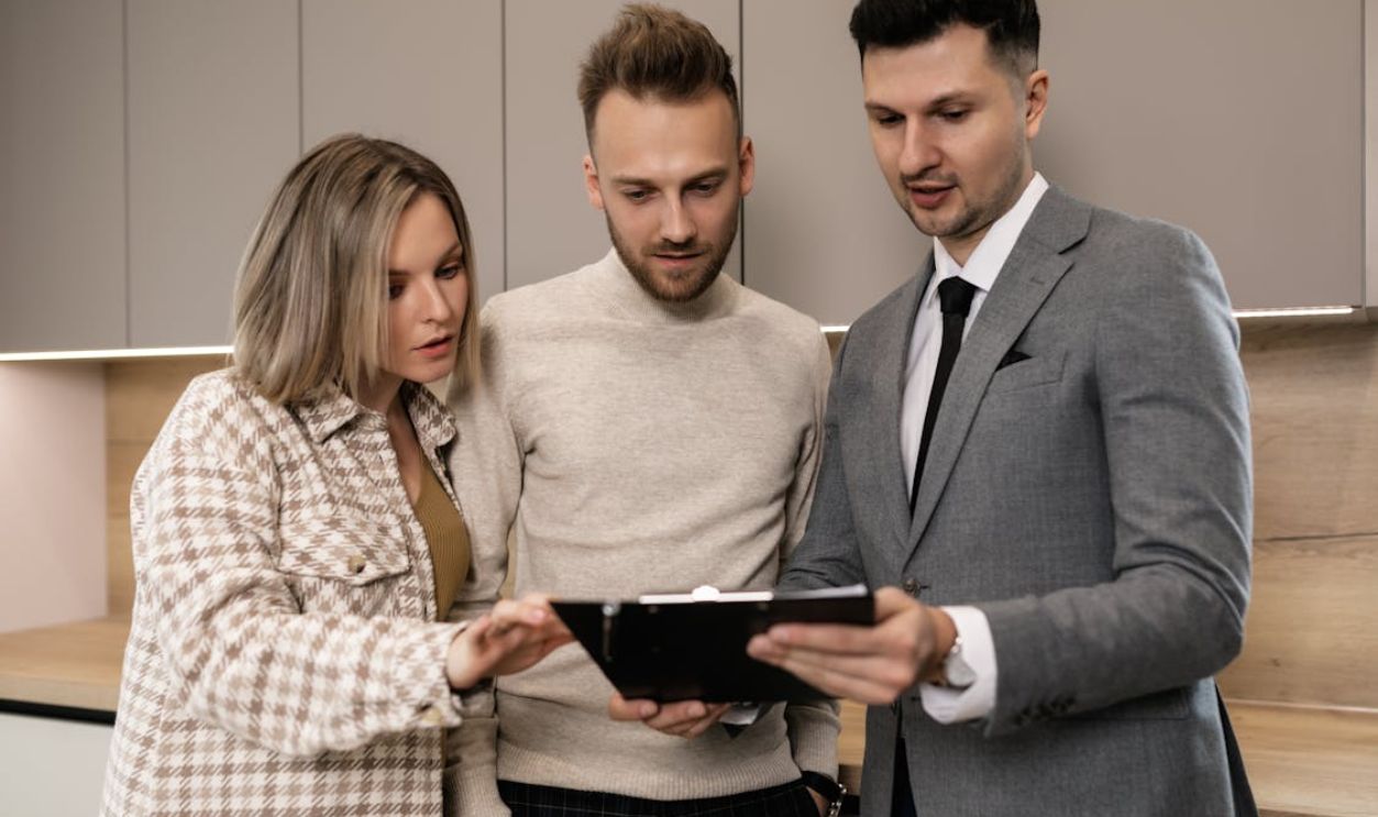 A Couple Looking at a Clipped Document