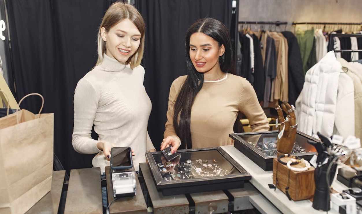 Women paying for clothes with smartphone