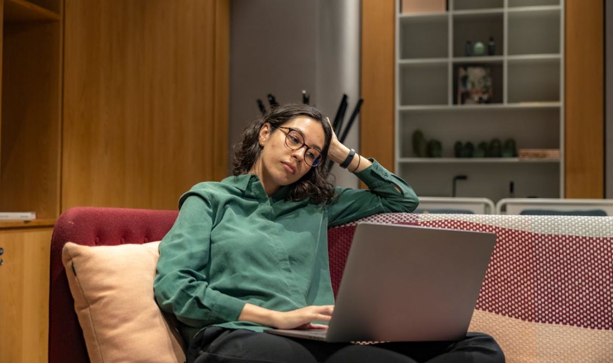 Young woman on laptop doing remote work in relaxing office environment
