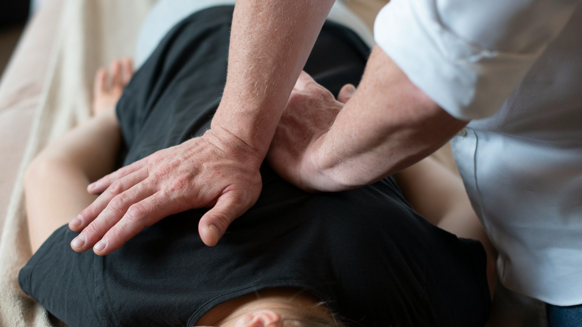 a woman getting a back massage from a man