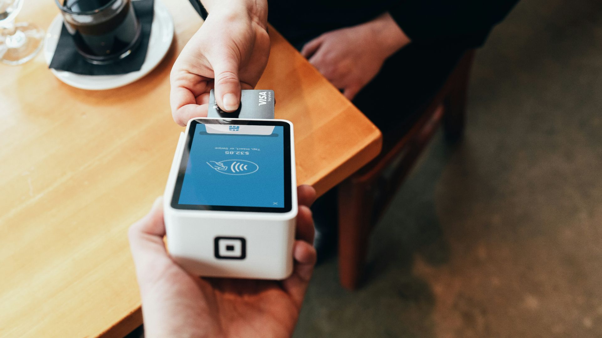 person holding credit card swipe machine