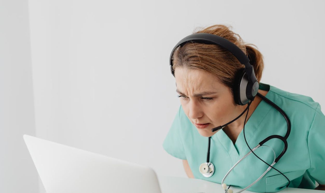Woman Squinting in Front of Laptop