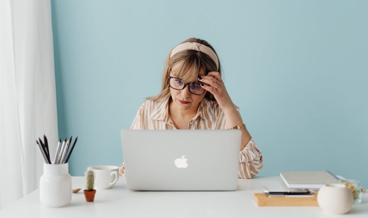 A Woman Sitting in front of a Laptop