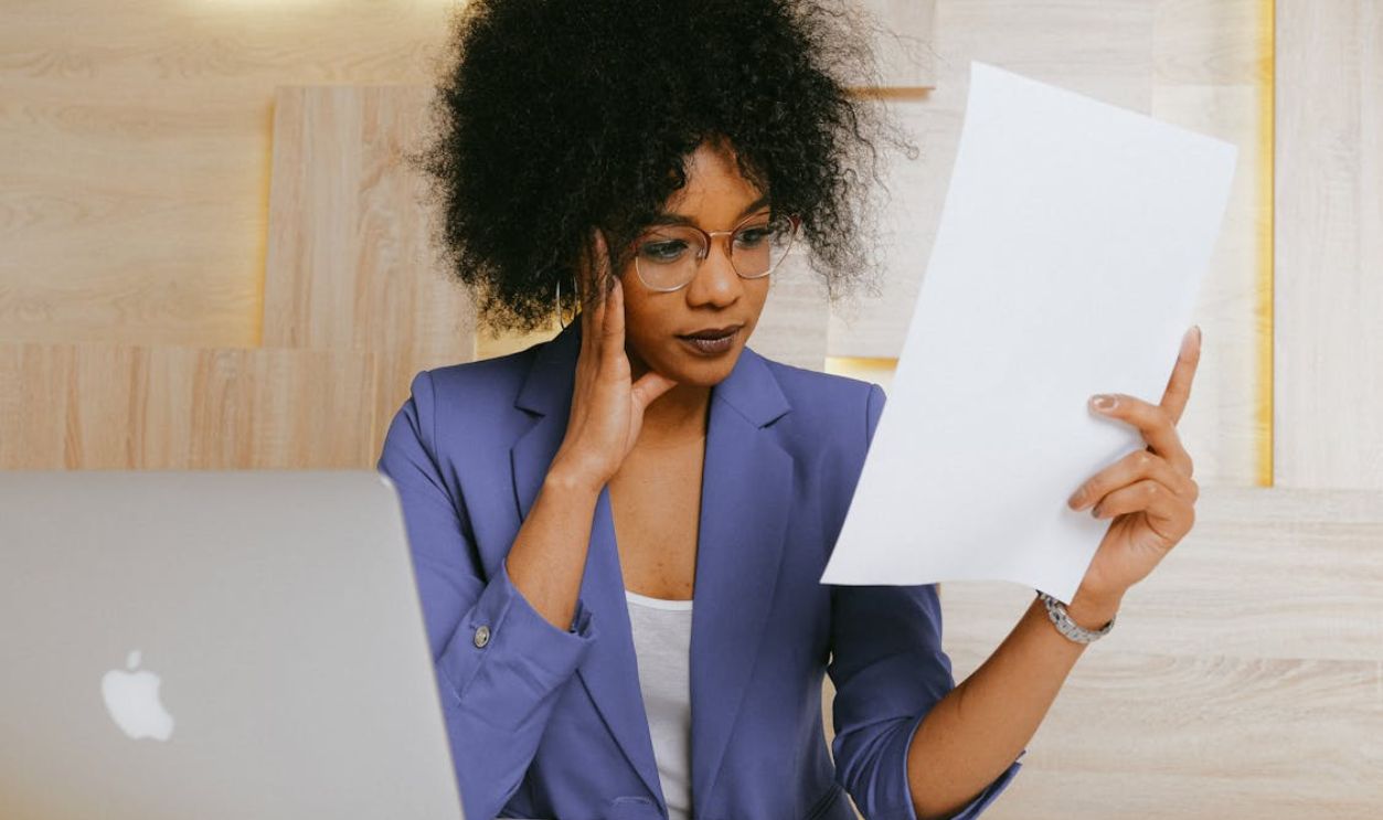Woman In Blue Blazer Holding White Paper