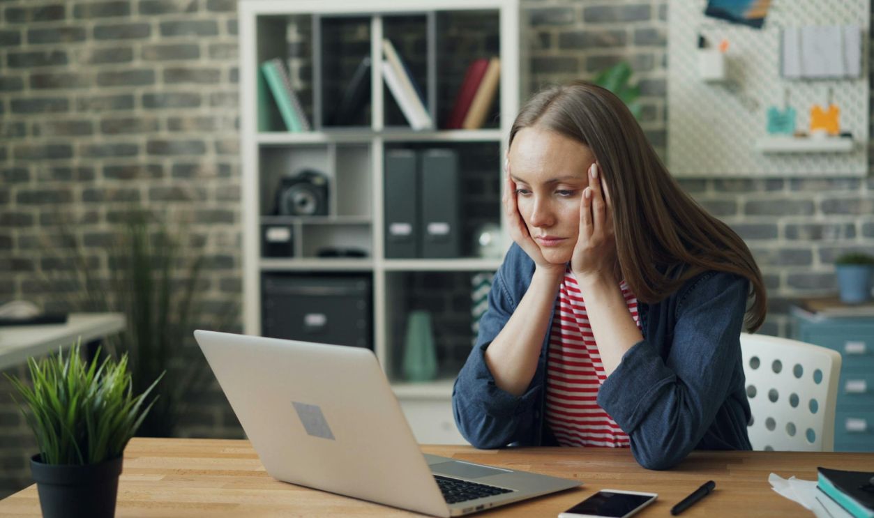 Worried Woman Looking at Computer in Office