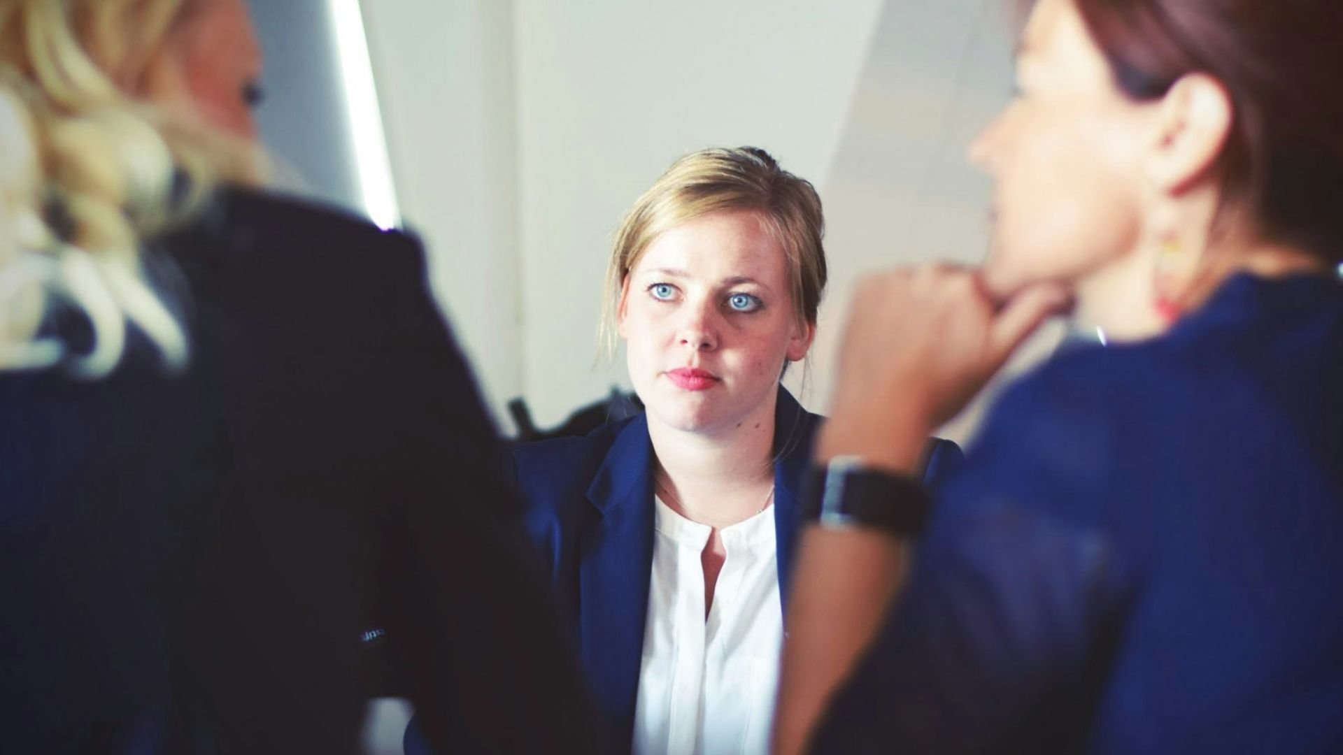 three women sitting beside table